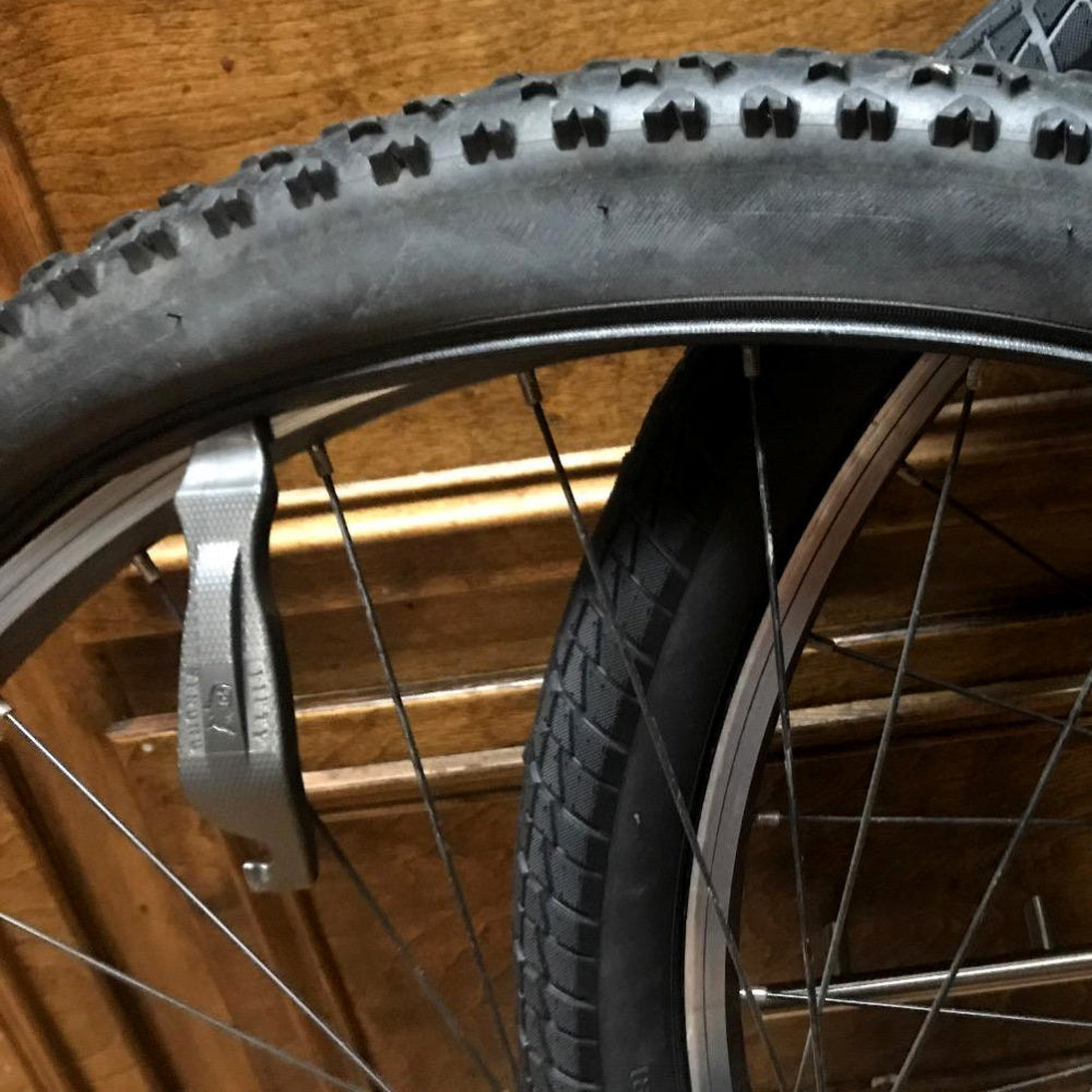 Close-up of a bicycle tire and rim with a wooden background